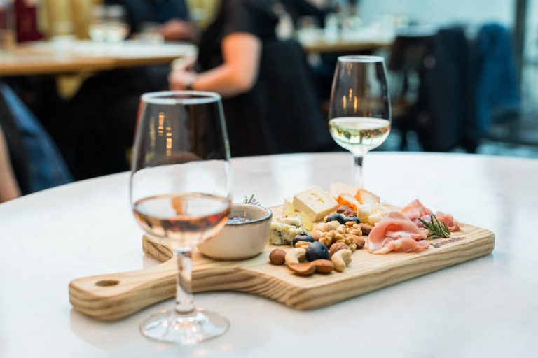 Cheese and charcuterie board served with glasses of rose and white wine in Palma