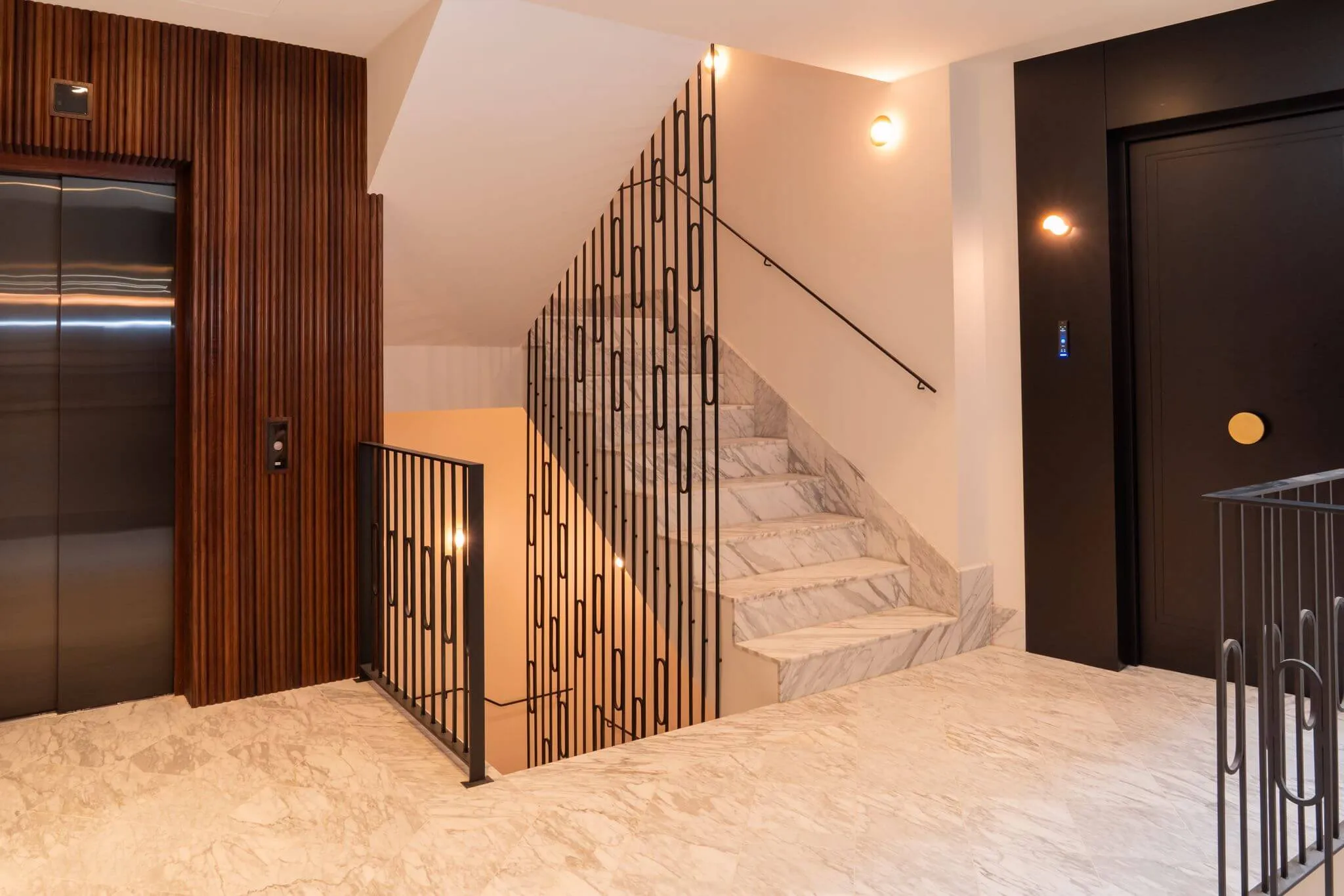 Marble staircase and lift in the entrance hall of Casa Roca in Palma