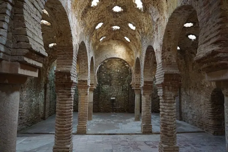 Stone columns and horseshoe arches inside the Arab Baths in Palma Old Town