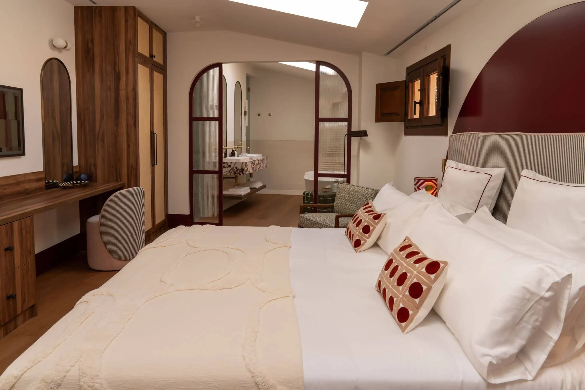 Penthouse bedroom with arched doorways at Casa Roca in Palma