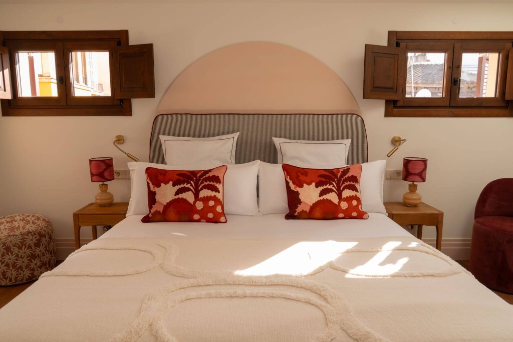 Double bedroom with an arched headboard in the Casa Roca penthouse