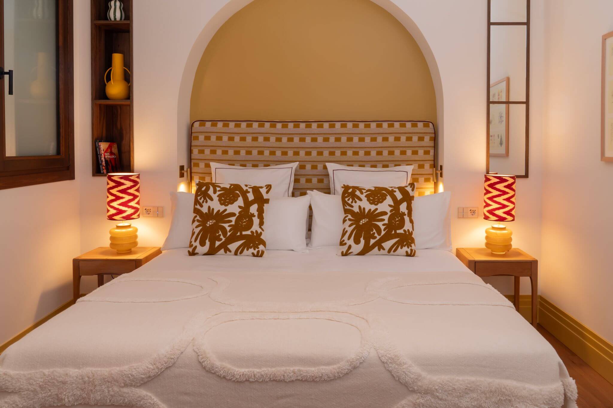Penthouse bedroom with red bedside lamps at Casa Roca in Palma