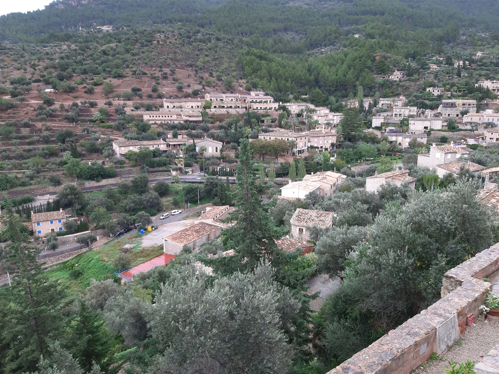 The village of Deia set among olive terraces on the Tramuntana hillside