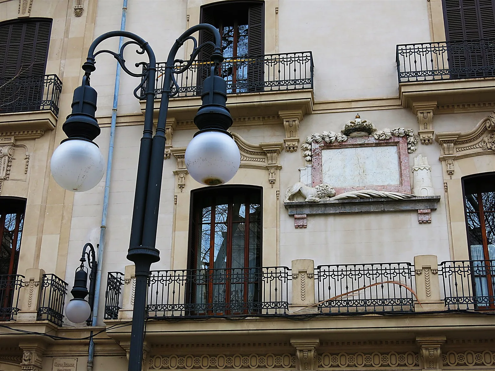 Wrought iron balconies and ornate street lamps on Passeig del Born in Palma Old Town