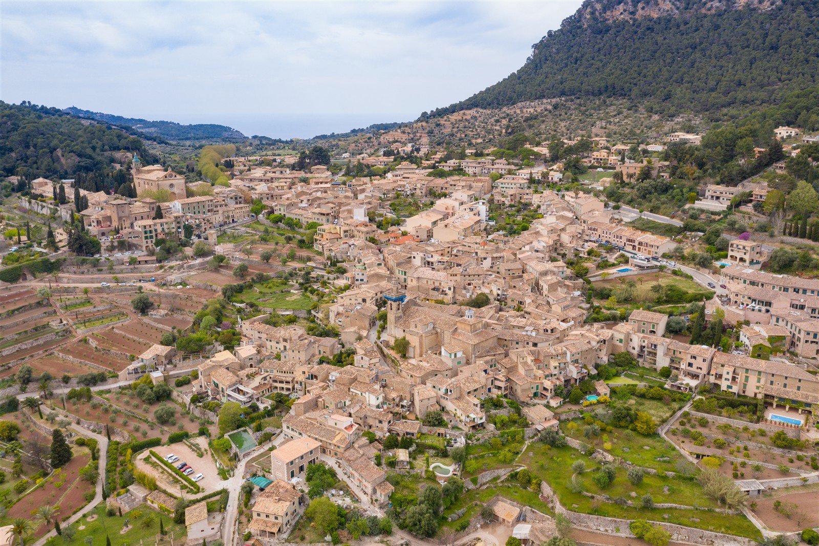 Aerial view of Valldemossa village and its stone houses below the Serra de Tramuntana