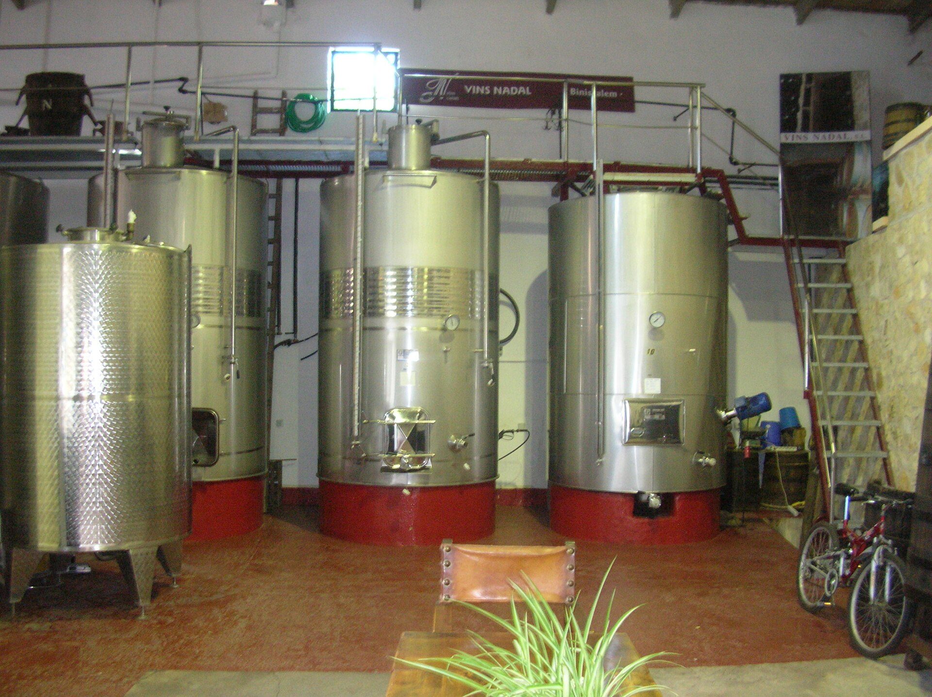 Stainless steel fermentation tanks inside a winery cellar in Binissalem Mallorca