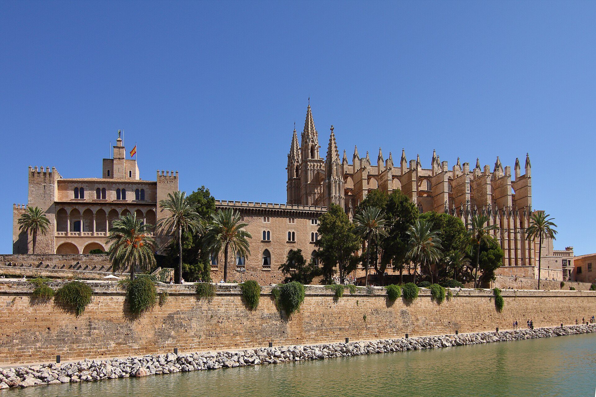 Palma Cathedral and the Almudaina Palace above the old city walls seen from the Parc de la Mar lake