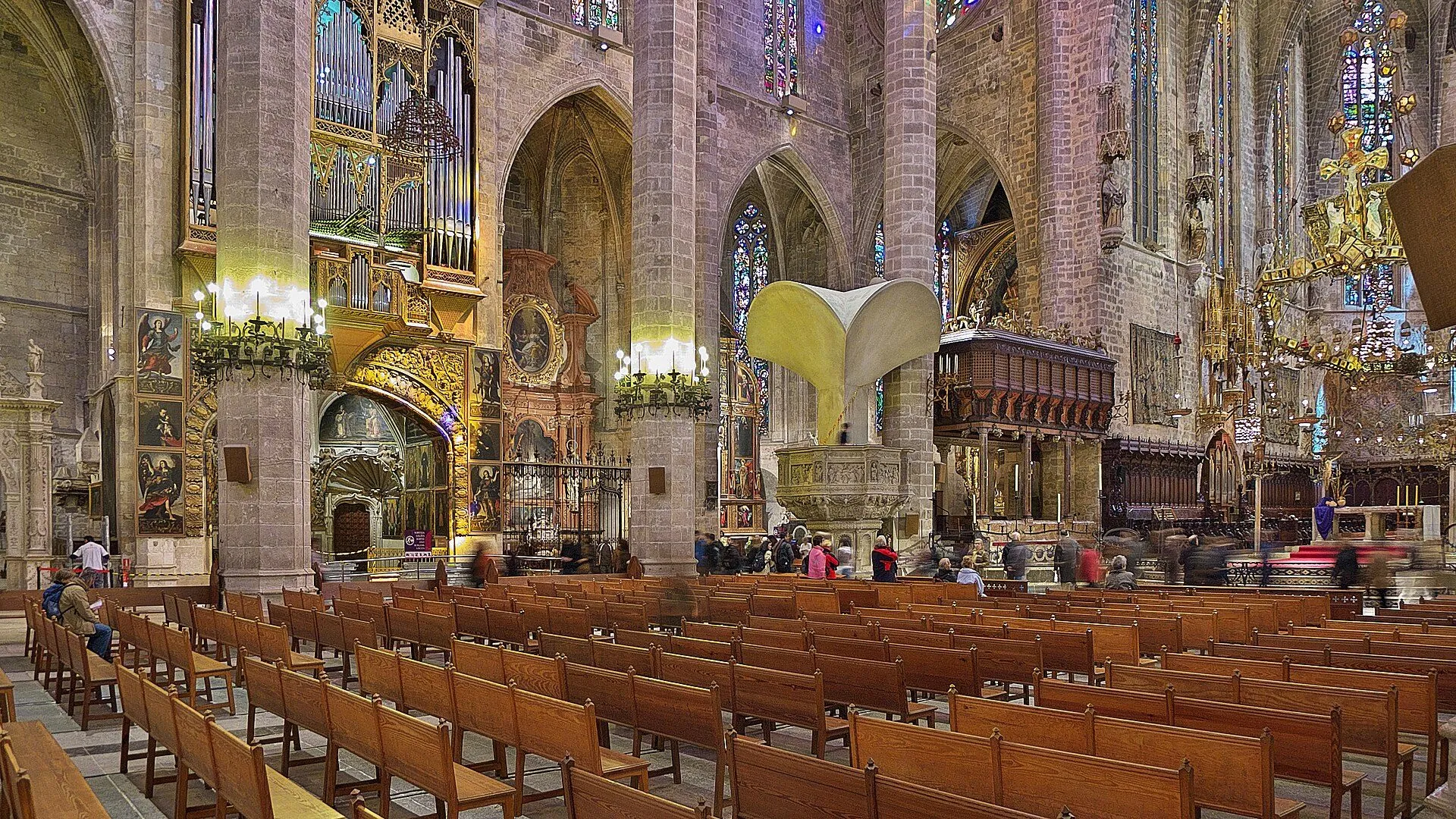 Interior of Palma Cathedral La Seu with the nave, pews and Gaudi canopy