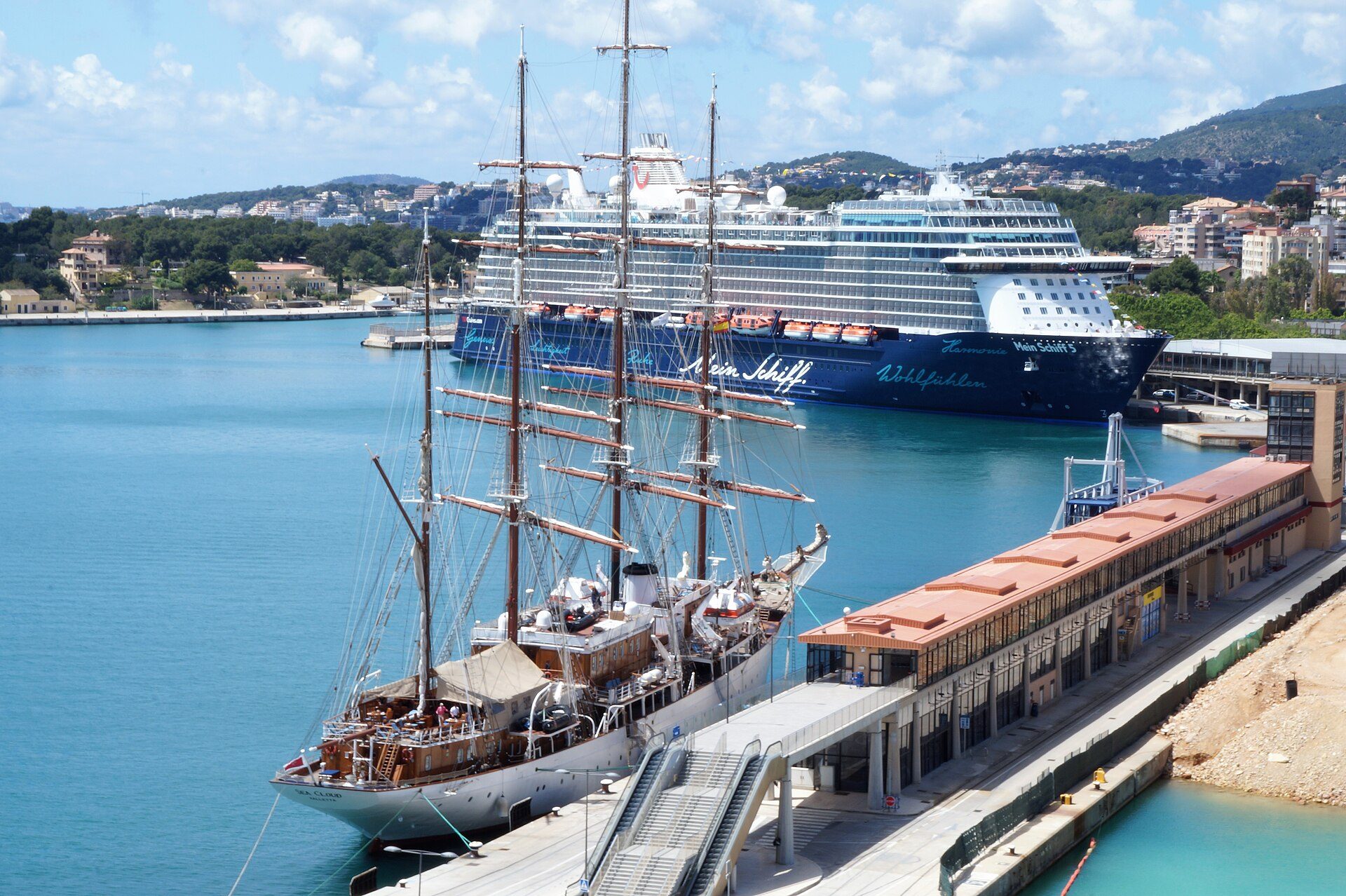 Cruise ship docked at the Palma de Mallorca cruise port beside a tall ship