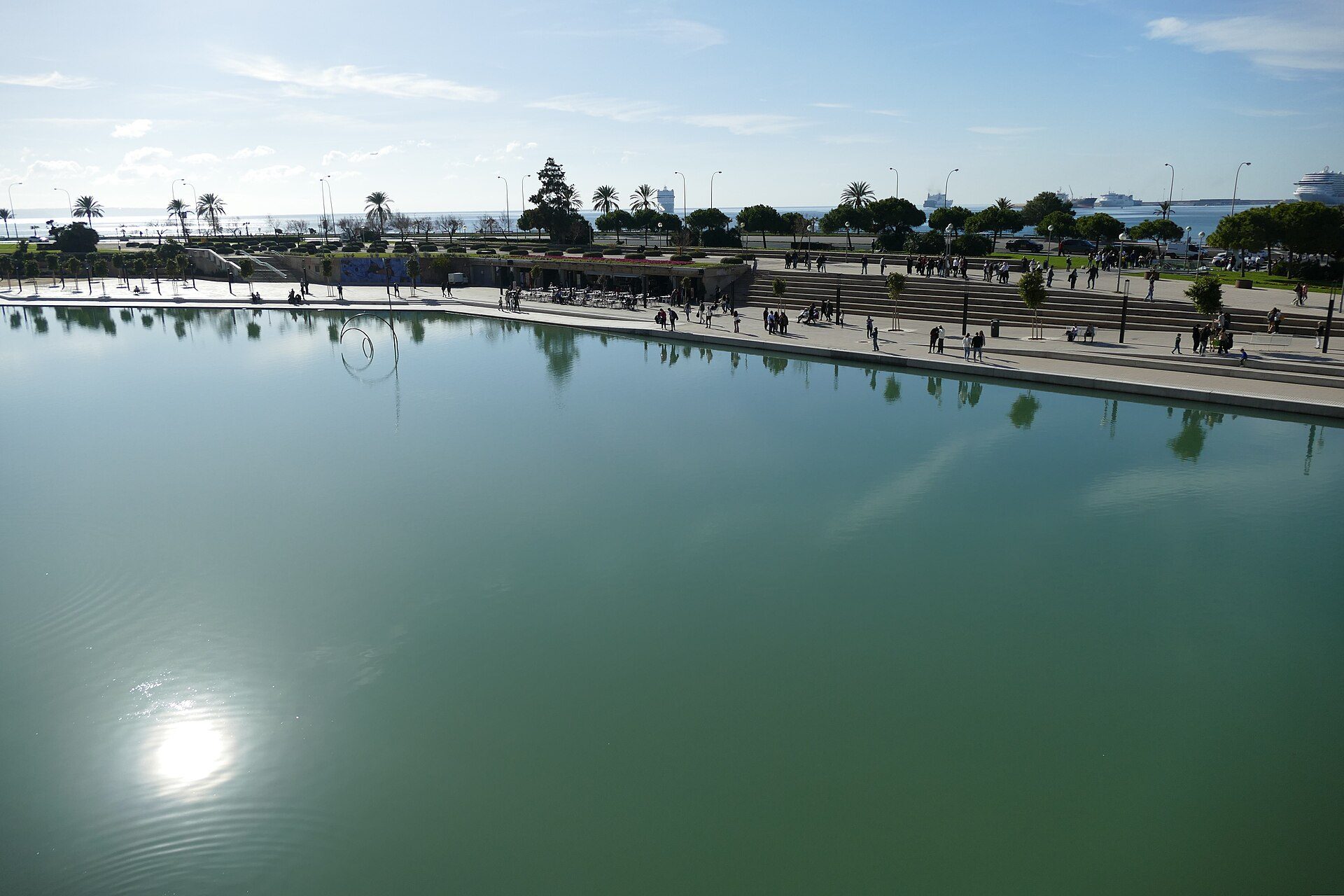 Parc de la Mar lake and seafront promenade in Palma with cruise ships in the distance