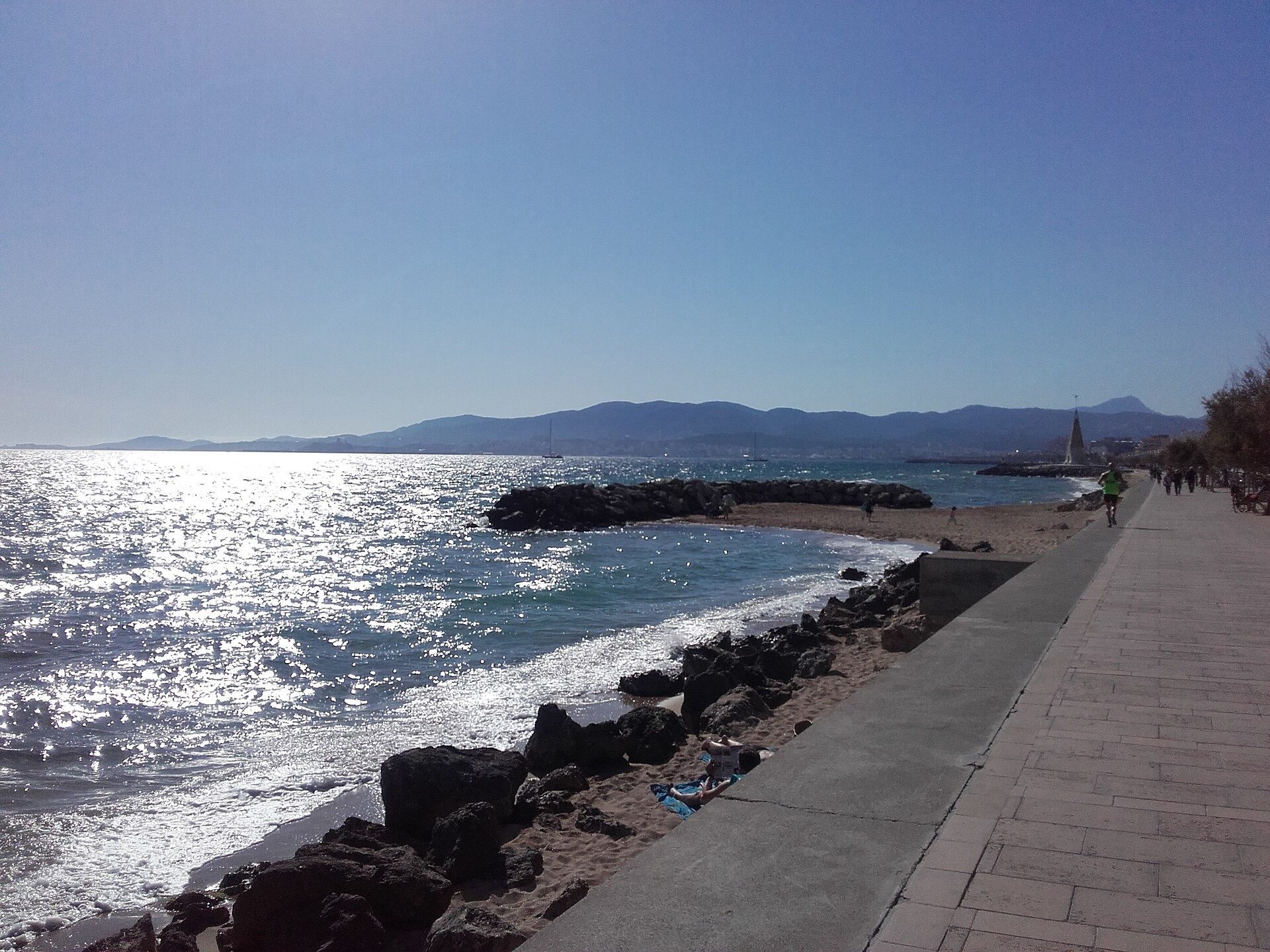 Seafront promenade at Portixol in Palma with the bay and mountains beyond